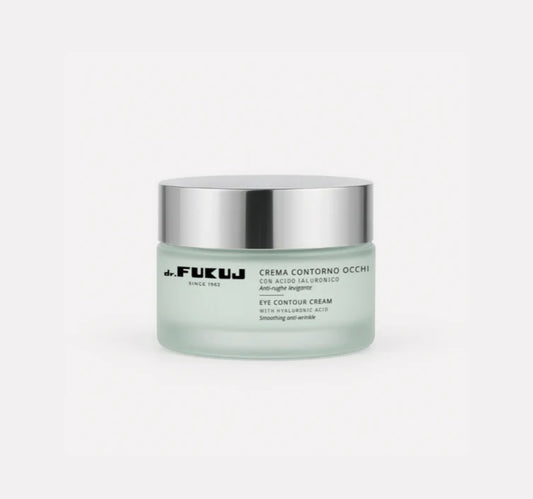 Jar of eye contour cream with silver lid on a white background